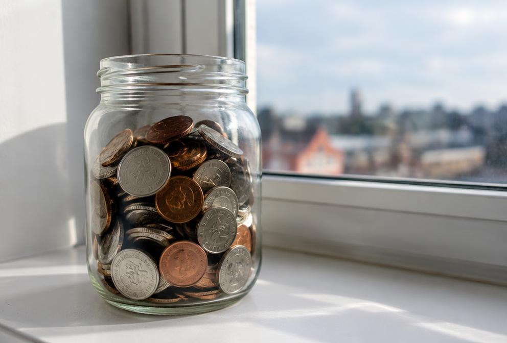 Glass jar of coins — illustrative detail